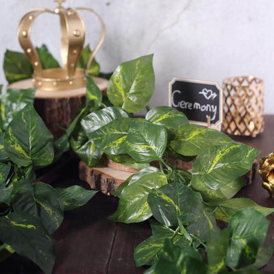 Artificial green leaves for decoration, perfect for events and ceremonies.