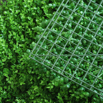 Green plastic grid on lush artificial foliage