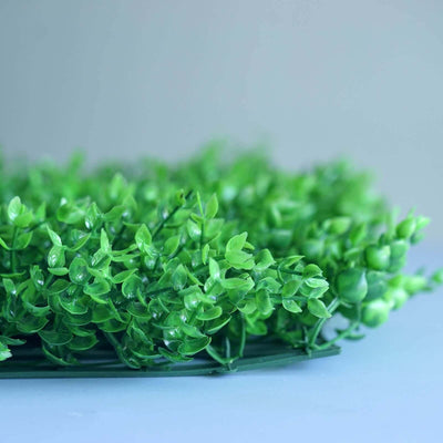 Artificial green foliage arrangement with lush leaves.