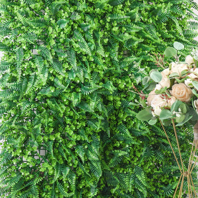 Artificial green foliage wall decoration with floral arrangement.