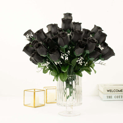 Black rose bouquet in a clear vase with decorative accents.