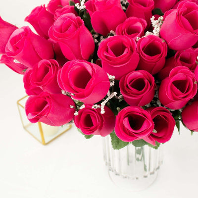 Bright pink artificial rose bouquet in a clear vase.