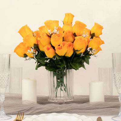 Bouquet of yellow roses in a clear vase on a table setting