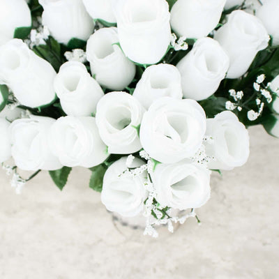 White artificial roses bouquet in a clear vase.