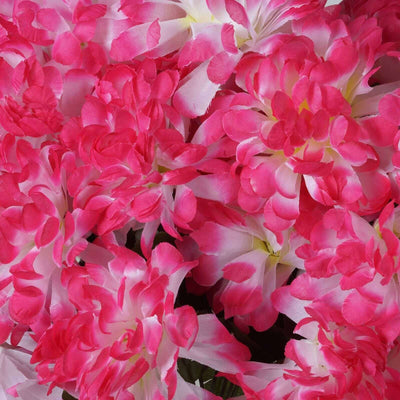 Vibrant pink and white artificial flowers in full bloom.