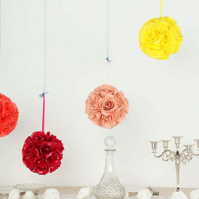 Hanging floral ball decorations in red, pink, and yellow against a white background