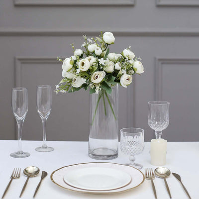 Elegant floral centerpiece with tableware for a refined dining setting.
