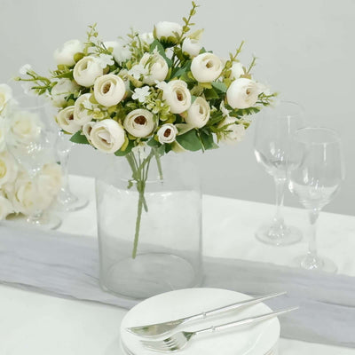 Elegant white rose bouquet in a glass vase on a dining table.
