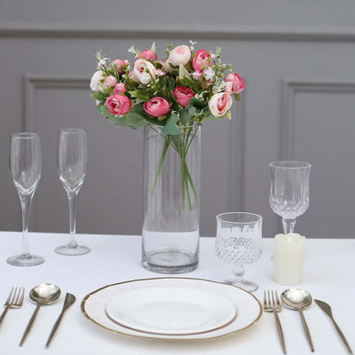 Elegant floral centerpiece with table setting and glassware.