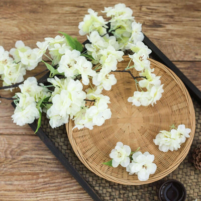 White floral arrangement on a woven plate with decorative elements.