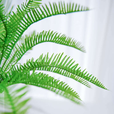 Artificial green fern leaves close-up, showcasing vibrant texture and detail.