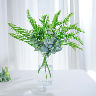 Artificial greenery arrangement in a clear vase