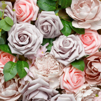 Assorted artificial roses in soft pink and lavender hues with green leaves.