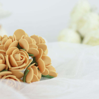 Peach-colored sugar flowers arranged elegantly on a white surface.