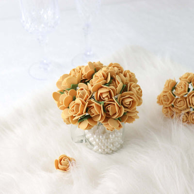 Yellow paper roses in a glass vase with decorative pearls.