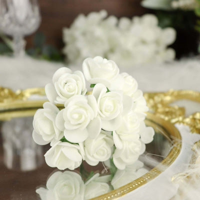 White rose bouquet arrangement on a reflective surface.