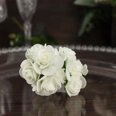 White artificial rose bouquet on a wooden surface.