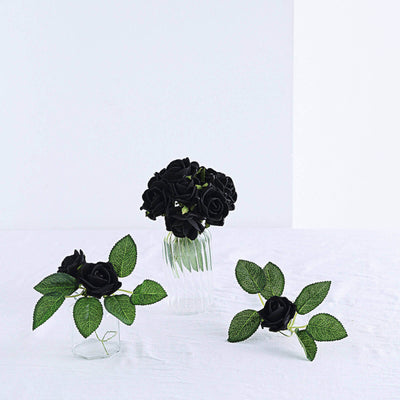 Black rose arrangements in glass vases with green leaves.