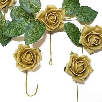 Artificial cream roses with green leaves on a plain background.