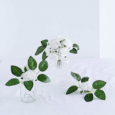 White rose bouquet with green leaves in glass vases