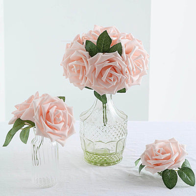 Soft pink artificial roses in glass vases, showcasing elegant floral design.