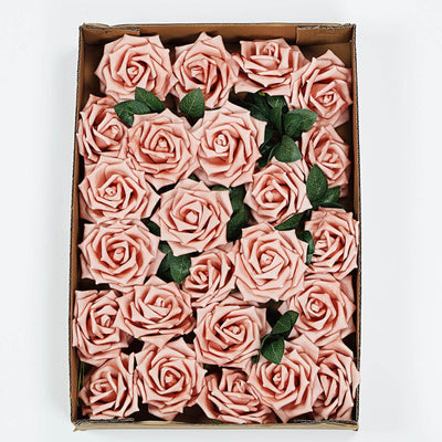 Box of artificial pink roses with green leaves, arranged neatly.