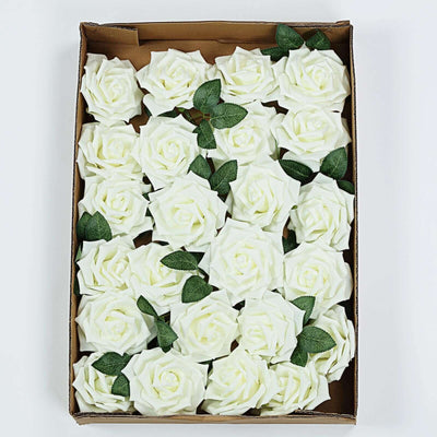Box of artificial white roses with green leaves.