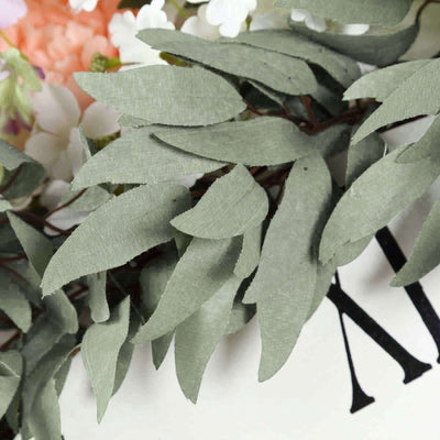Green foliage leaves on a decorative floral arrangement.