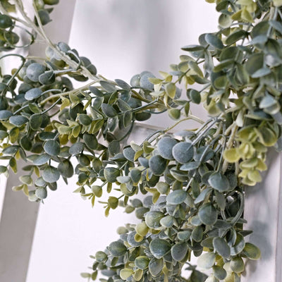 Green faux succulent garland on a white background