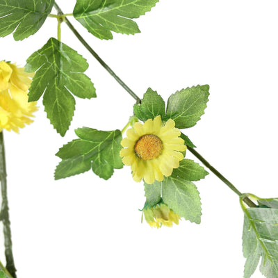 Yellow flower garland with green leaves on a white background.