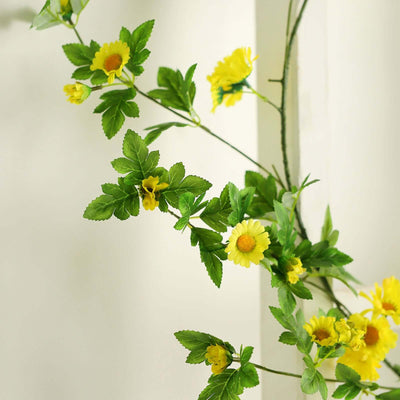 Yellow flower vine decoration with green leaves.