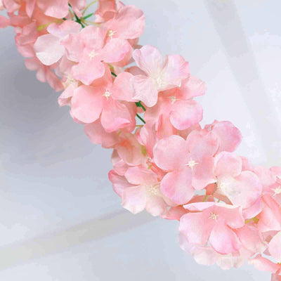 Pink hydrangea flower garland on a plain backdrop