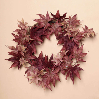 Autumn-inspired decorative wreath with red and burgundy leaves.