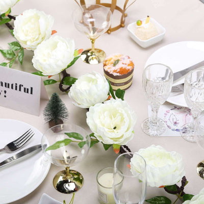 Elegant table setting with white flowers and decorative glassware.
