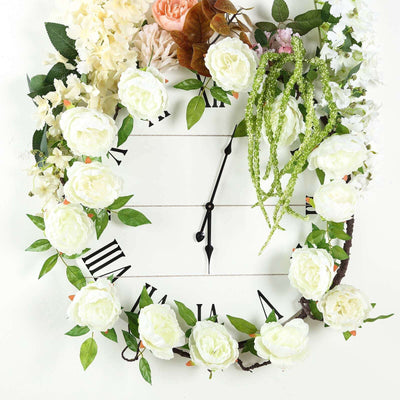 Floral wall clock with white roses and greenery on a white background