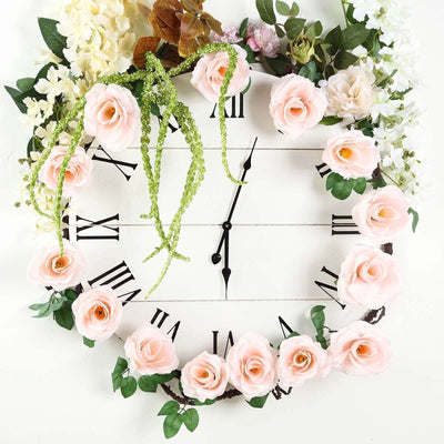 Floral wall clock adorned with pink roses and greenery.