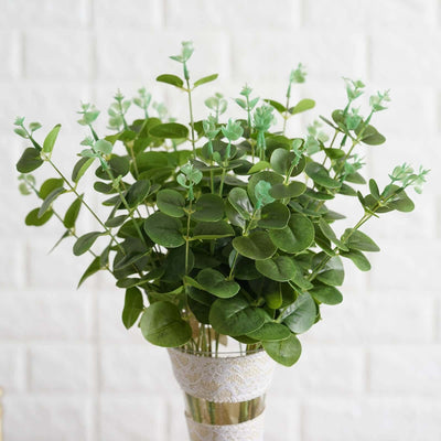 Artificial eucalyptus plant in a decorative vase.