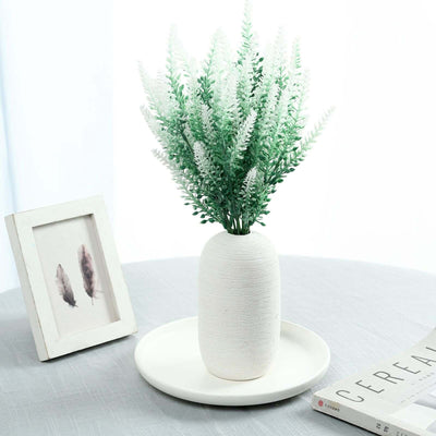 Decorative white vase with green flowers on a table