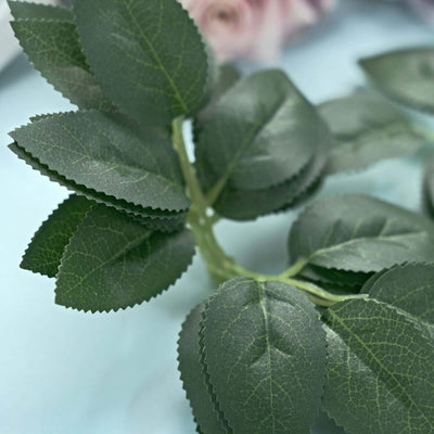 Artificial green leaf branch with textured leaves.