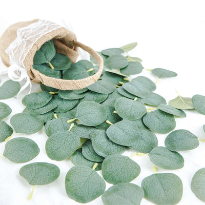 Green eucalyptus leaves spilling from a burlap bag.