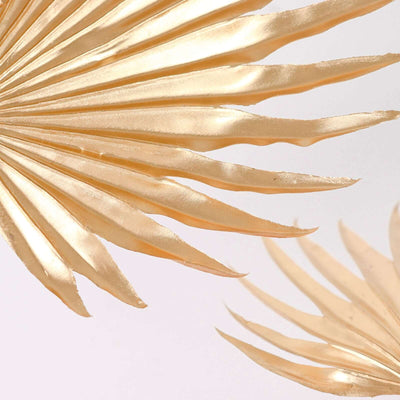 Gold palm leaf decor for stylish home accents.