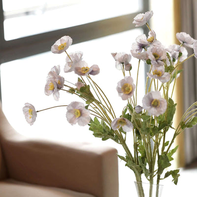 Artificial flower bouquet in a vase, adding elegance to home decor.
