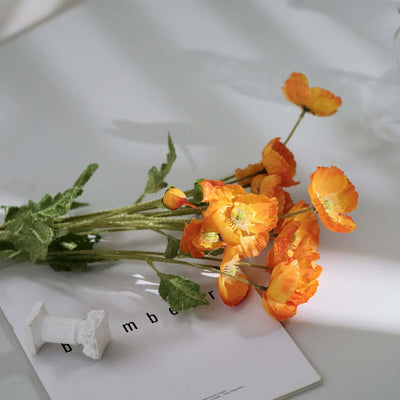 Bouquet of vibrant orange flowers on a magazine page.