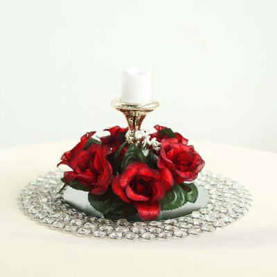 Red rose candle holder centerpiece with decorative crystals.