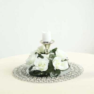 Elegant floral candle holder with white roses and crystal base.