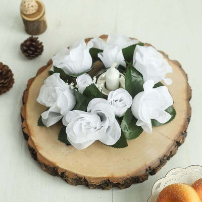 White rose candle centerpiece on a wood slice.