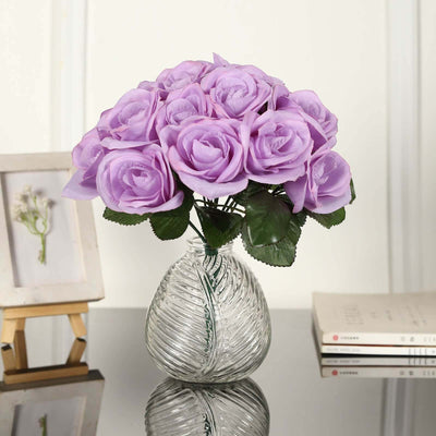 Purple artificial roses in a glass vase, adding elegance to any decor.