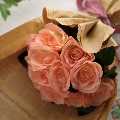 Bouquet of pink artificial roses wrapped in decorative paper