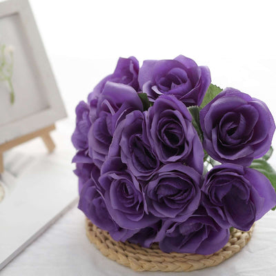 Purple artificial roses bouquet in a woven basket.