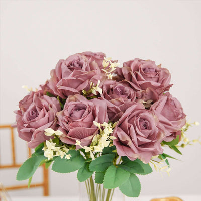 Purple artificial rose bouquet with greenery for home decor.